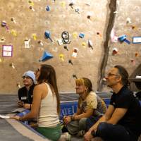 the 4-judge panel focusing on a finalist climbing